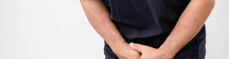 Pain on penis concept : Man use his hands to press on his penis on grey background. Used for Prostate cancer