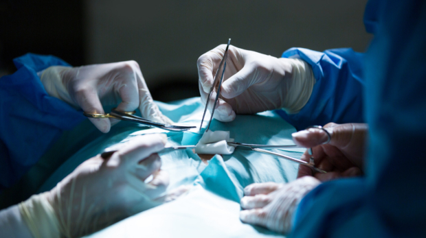 Surgeons performing operation in operation room at the hospital